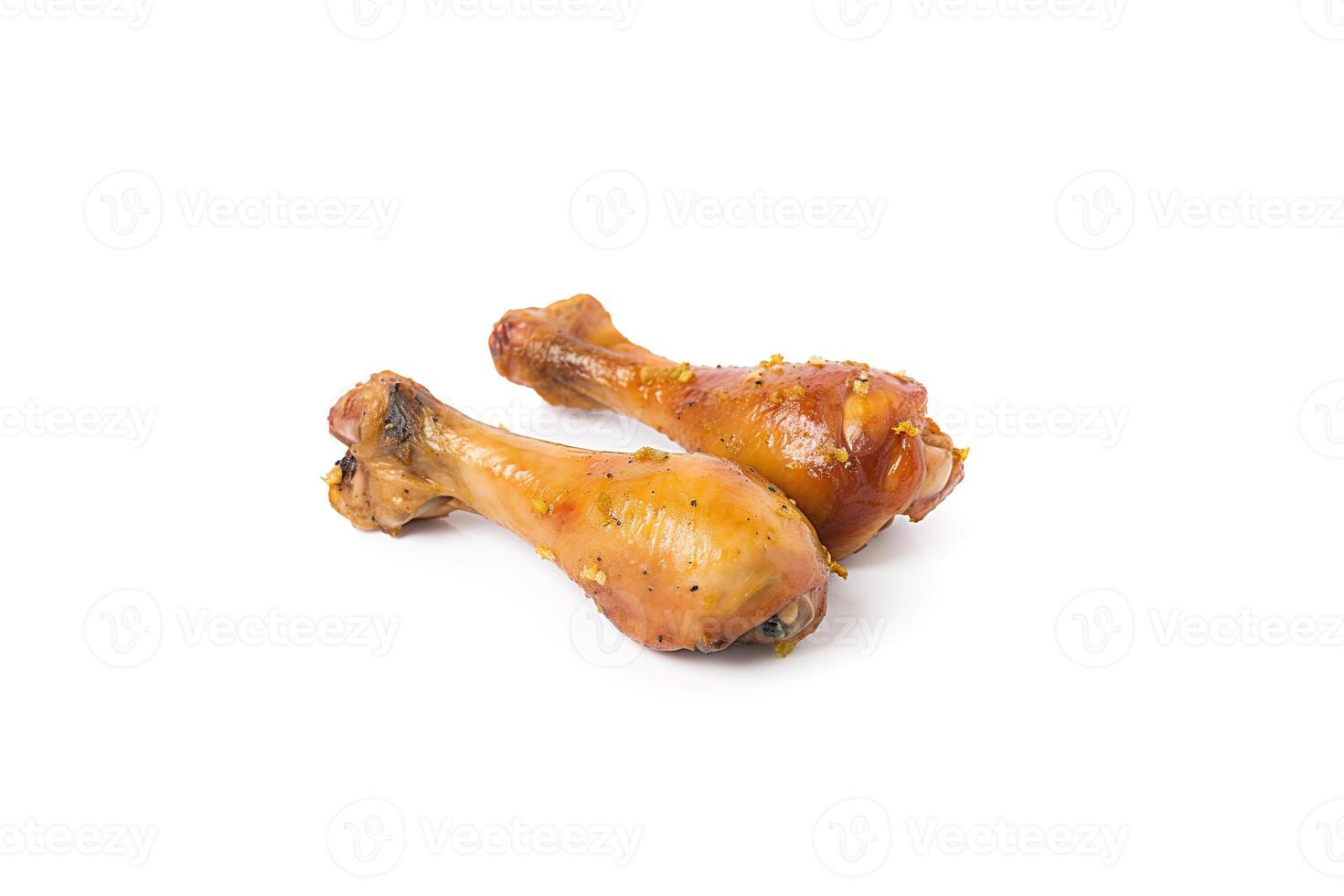 Delicious baked chicken drumsticks in honeymustard marinade isolated on white background. photo