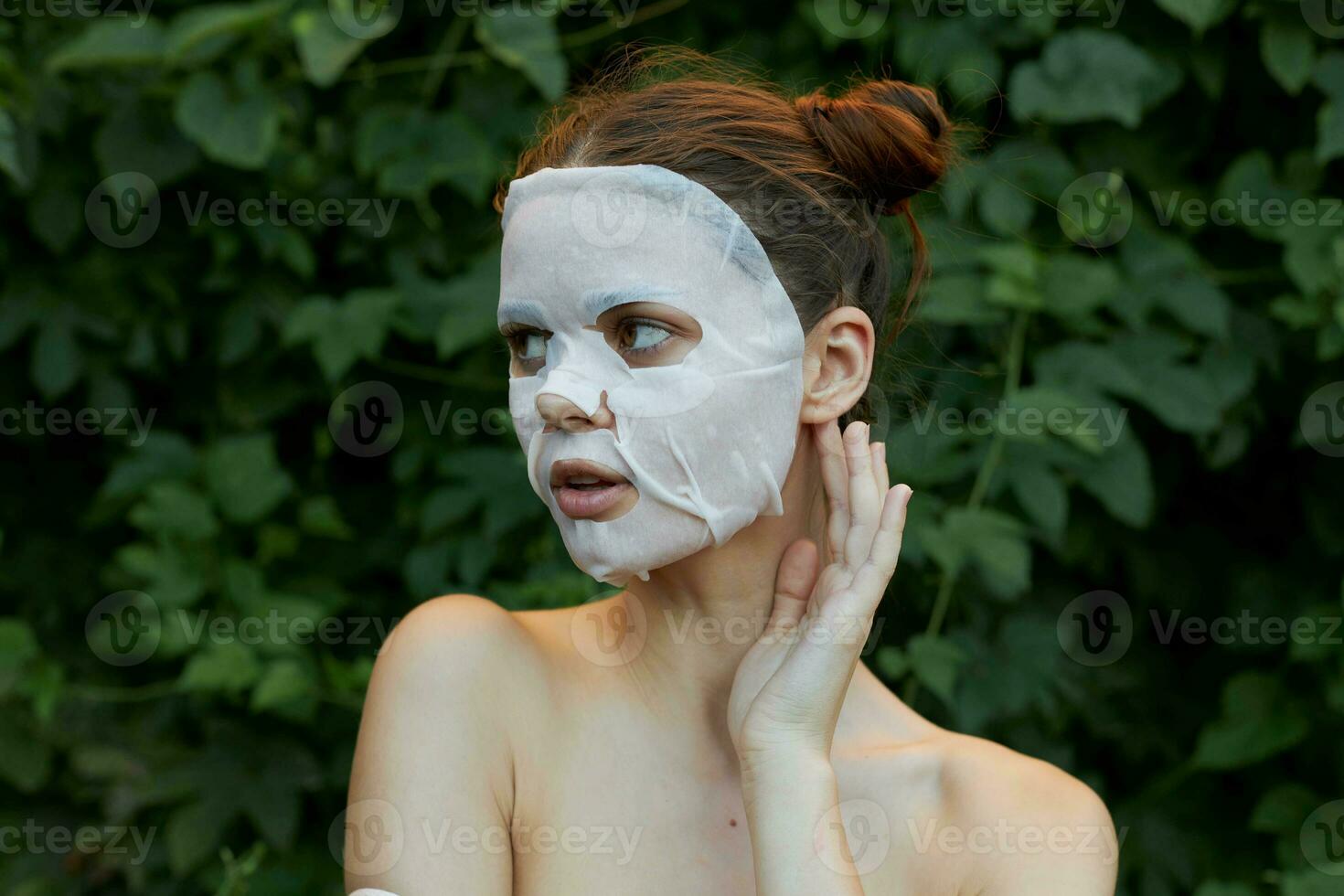 Beautiful woman Anti-wrinkle mask Touch your ear with your hand dermatology photo