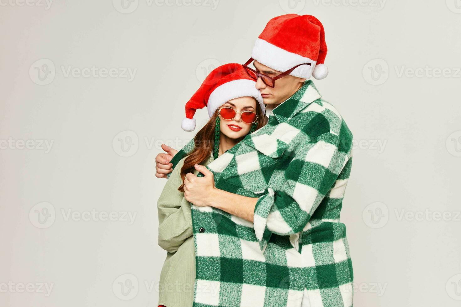 young couple green plaid shirt hugs holiday fun photo