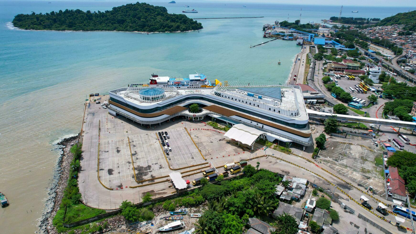 Aerial view of vehicles and passengers queueing to enter the ferry ship at the Merak Seaport. Banten, Indonesia, February 26, 2022 photo