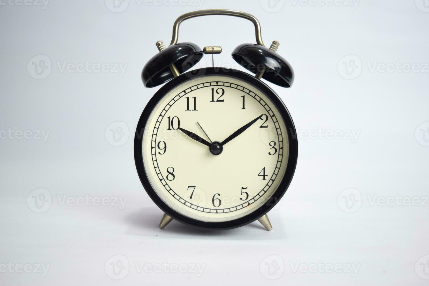 Clock ticking to 10 o'clock isolated on white background photo