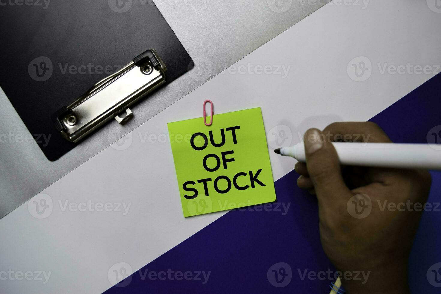 Out of Stock text on sticky notes with color office desk concept photo