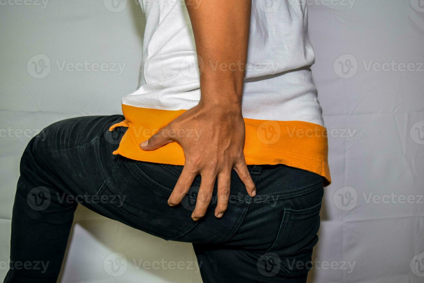 Close up Asian man shows he had Diarrhea isolated on white background photo