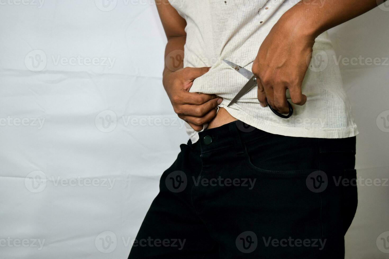 Close up Asian man wants to make a lipasuction with his black scissors isolated on white background photo