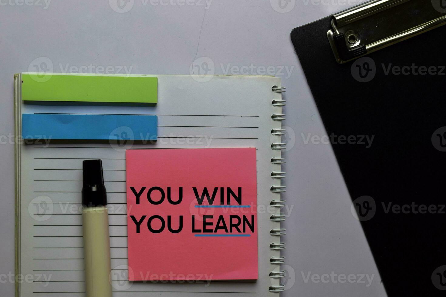 You Win You Learn write on sticky notes. Isolated on white table background photo