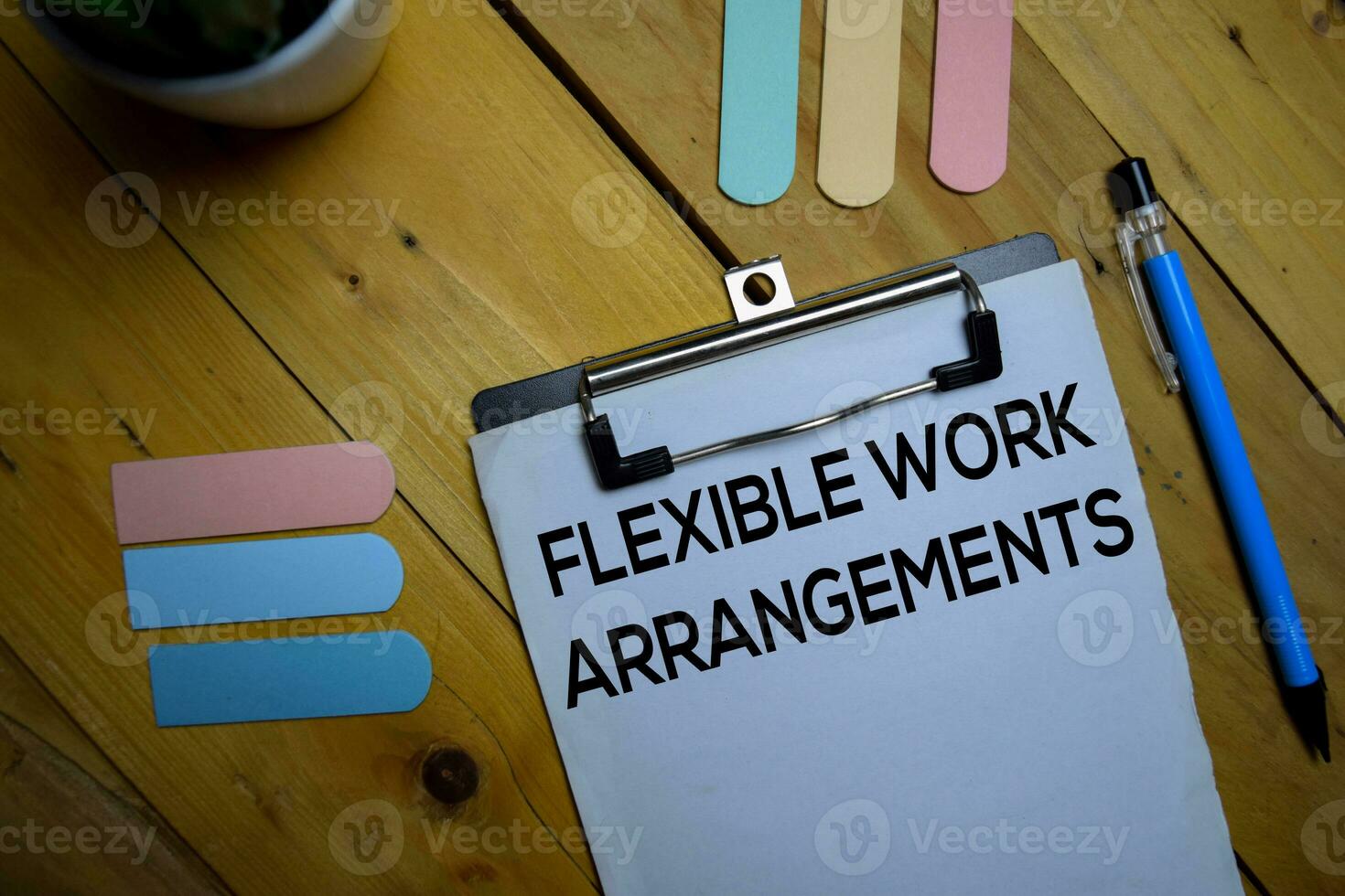 Flexible Work Arrangements write on a paperwork isolated on wooden background. photo
