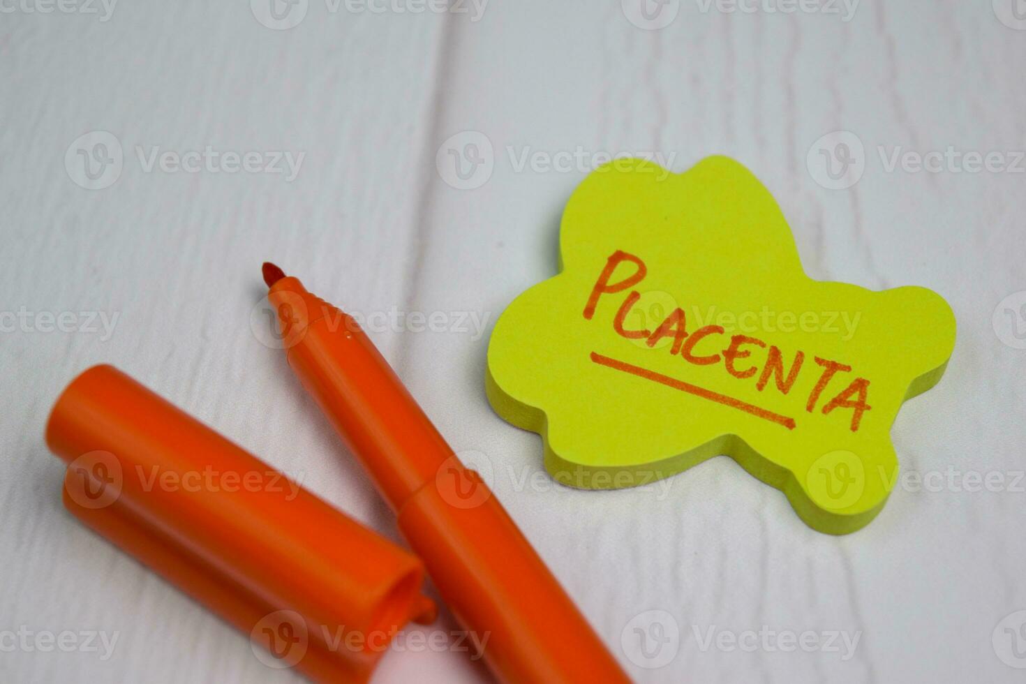 Placenta write on sticky notes isolated on office desk photo