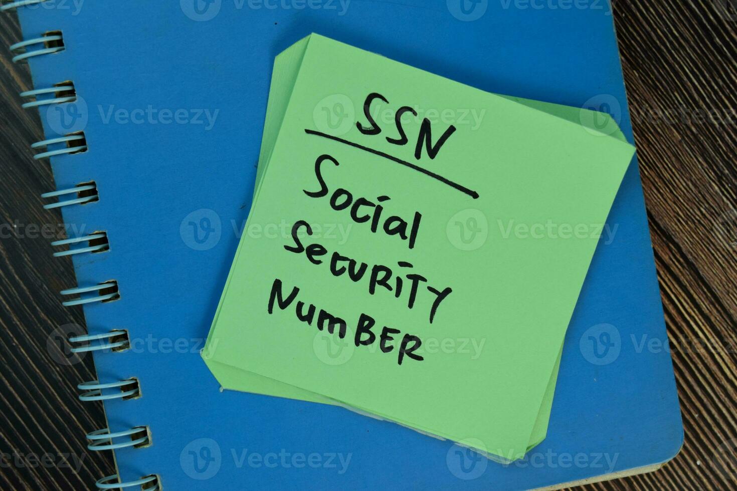 SSN Social Security Number write on sticky notes isolated on Wooden Table. 23634500 Stock