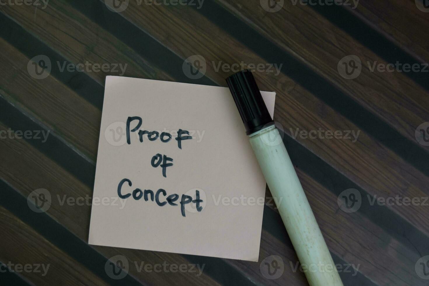 Proof of Concept write on sticky notes isolated on Wooden Table. photo