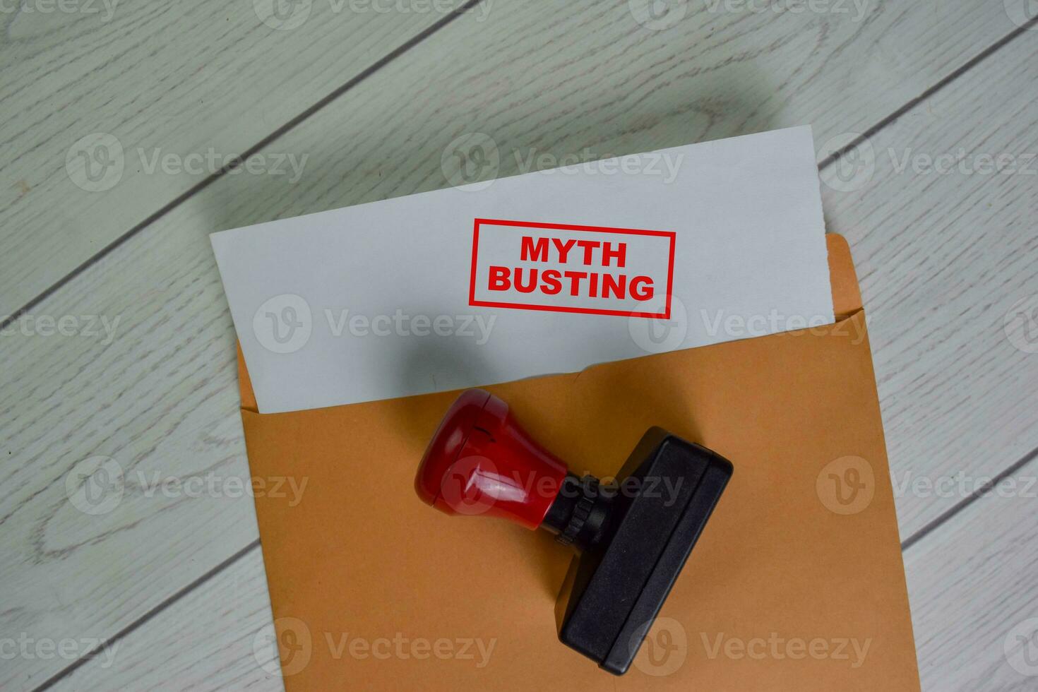 Myth Busting text on document above brown envelope. photo