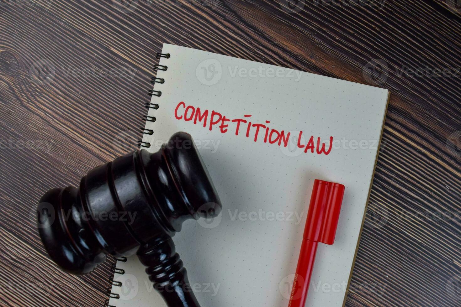 Competition Law write on a book isolated on Wooden Table. photo