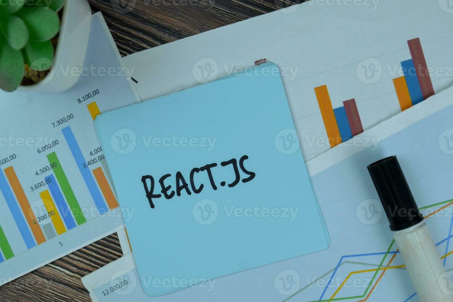 React.JS write on sticky notes isolated on Wooden Table. photo