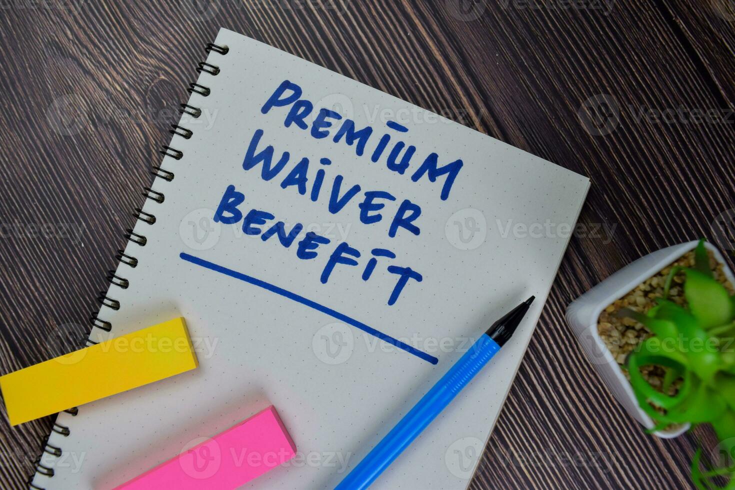 Premium Waiver Benefit write on a book isolated on Wooden Table. photo