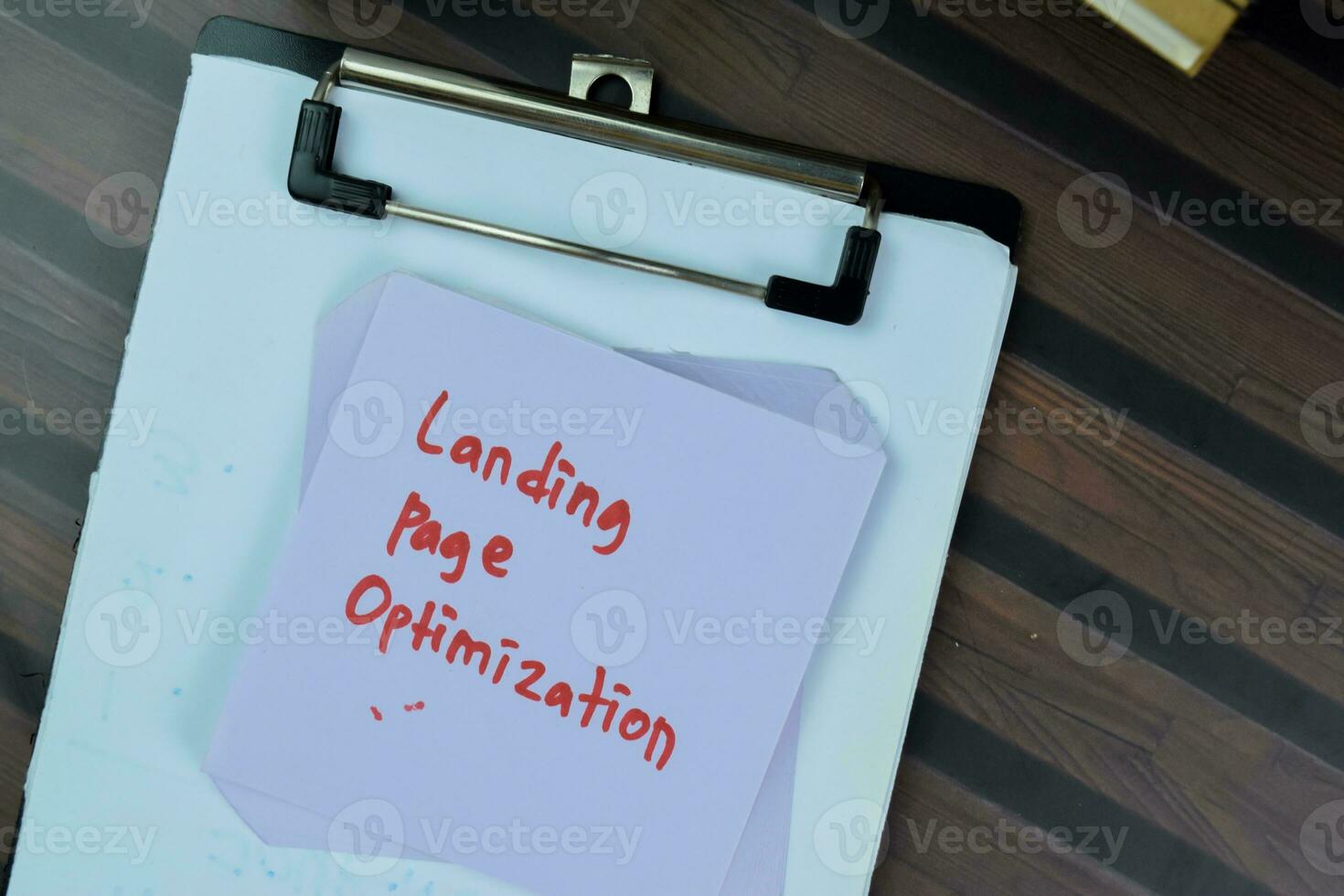 Concept of Landing Page Optimization write on sticky notes isolated on Wooden Table. photo