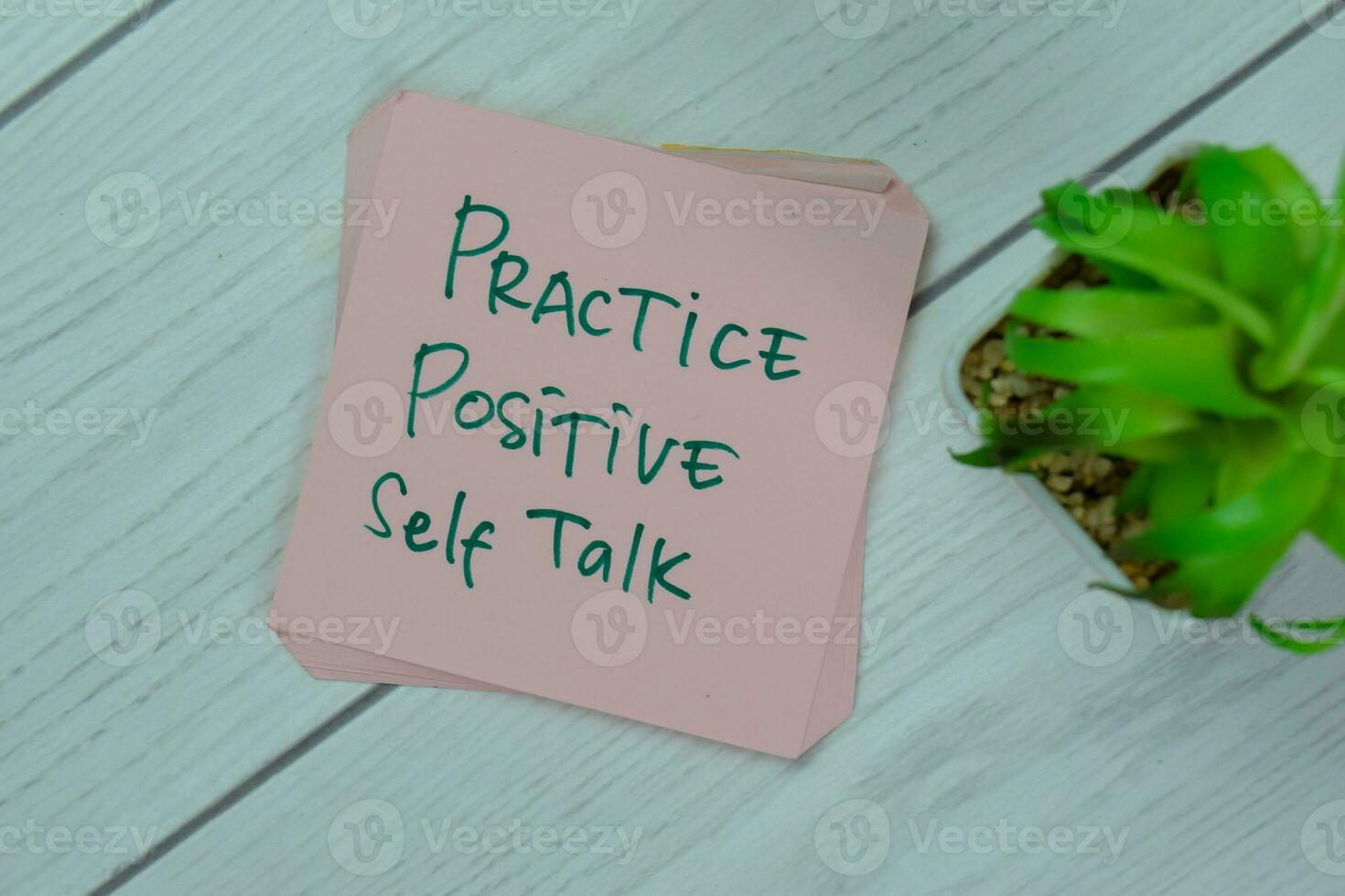 Concept of Practice Positive Self Talk write on sticky notes isolated on Wooden Table. photo
