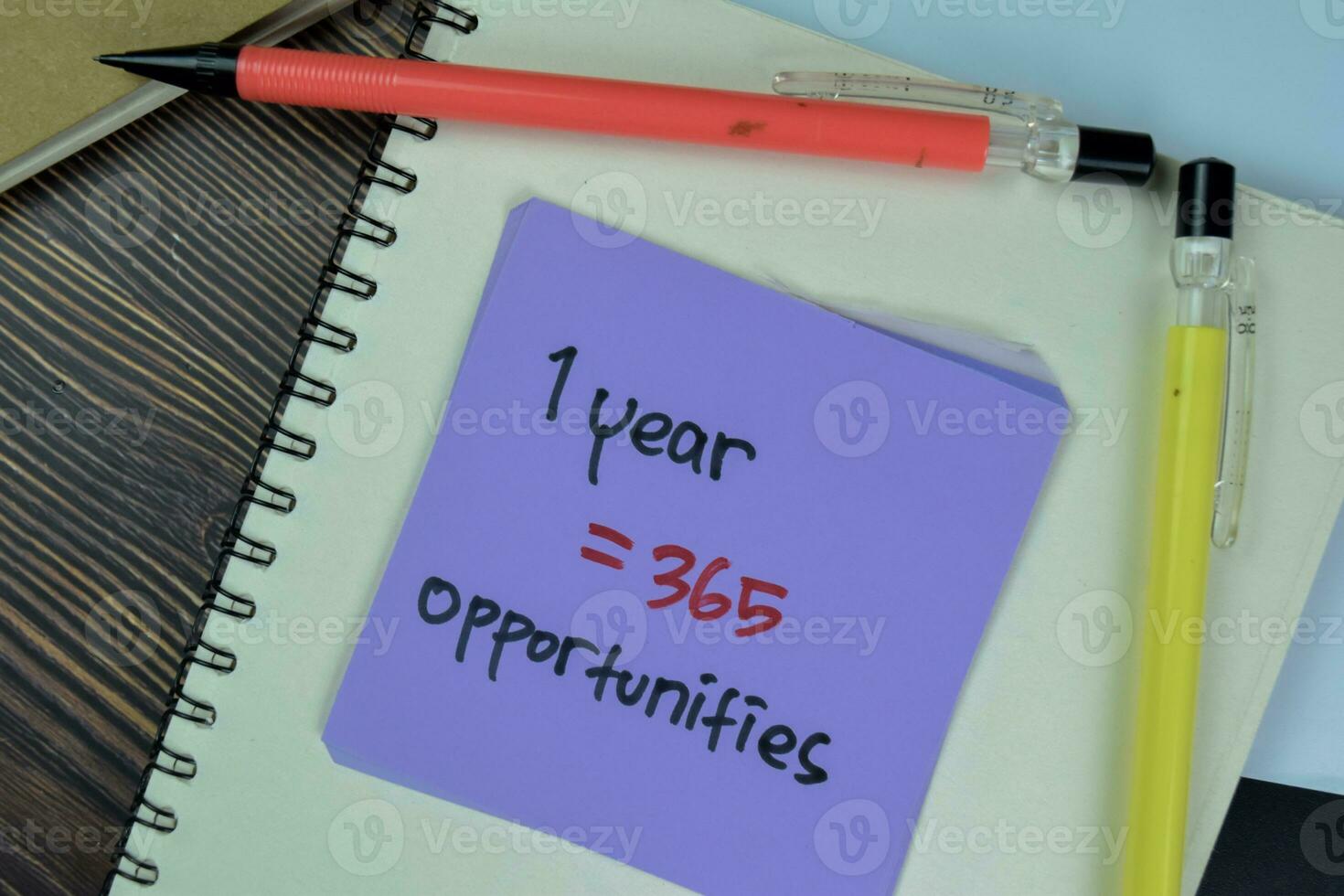 Concept of 1 Year  365 Opportunities write on sticky notes isolated on Wooden Table. photo
