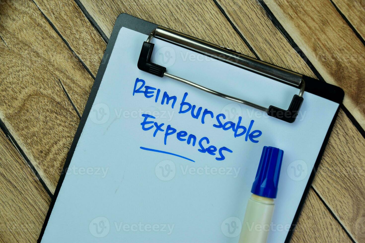 Concept of Reimbursable Expenses write on paperwork isolated on Wooden Table. photo