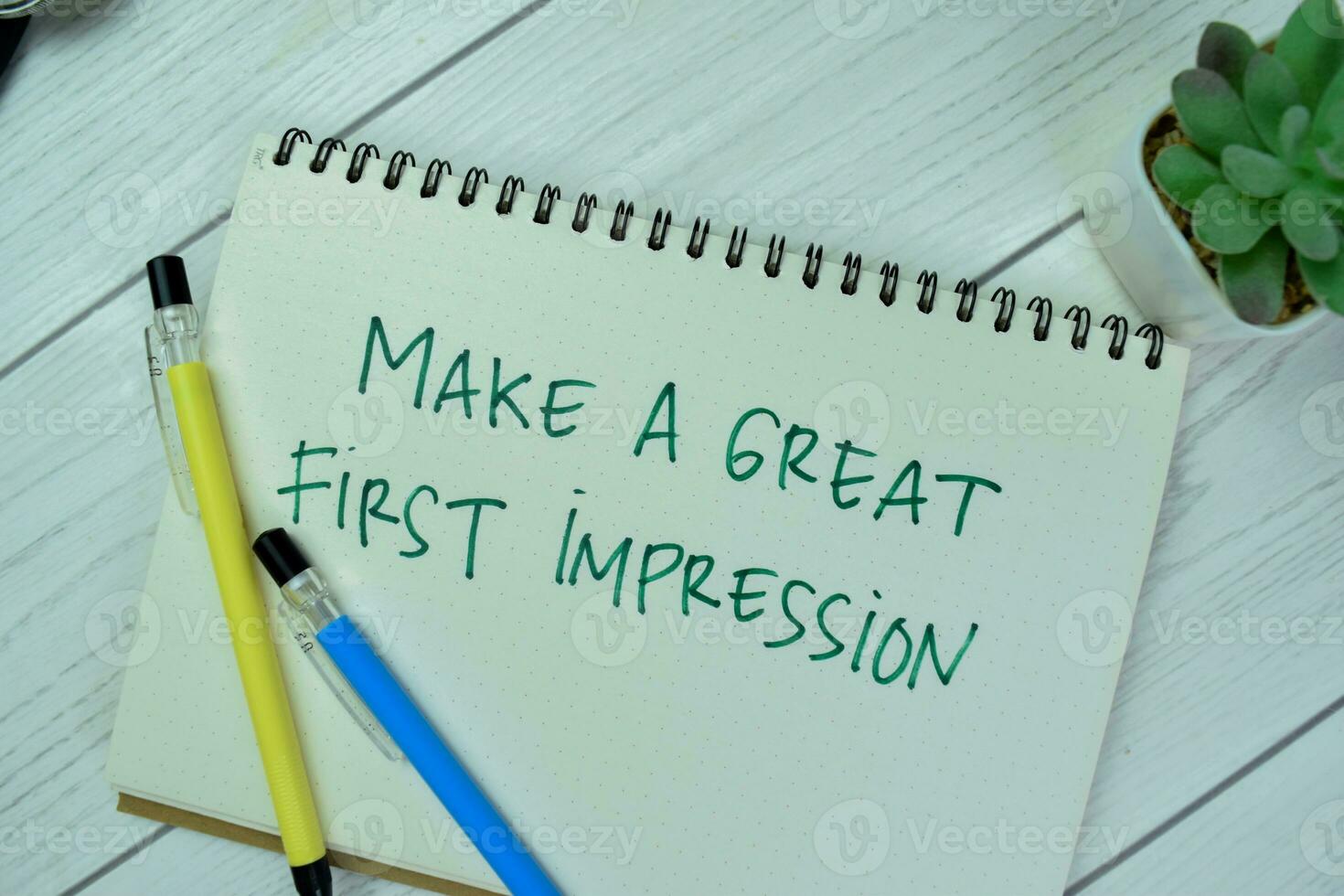 Concept of Make A Great First Impression write on a book isolated on Wooden Table. photo