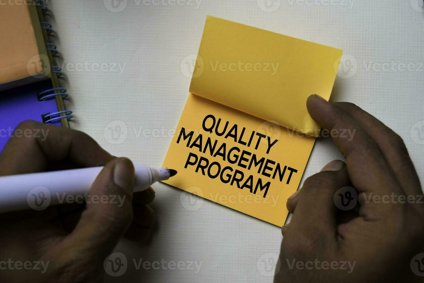 Quality Management Program text on sticky notes isolated on office desk photo