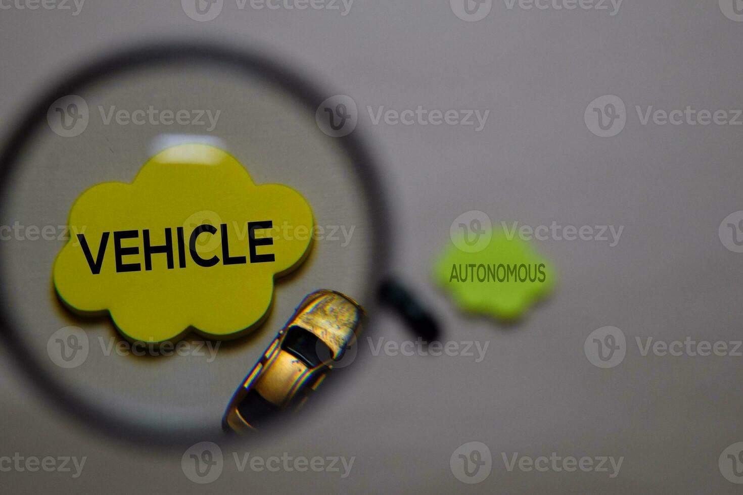 Vehicle or Autonomous write on a sticky note isolated on office desk. Selective focus on Vehicle text photo