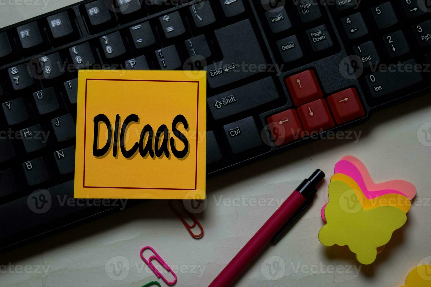 DICaaS - Data Intensive Computing as a Service write on a sticky note isolated on office desk. photo