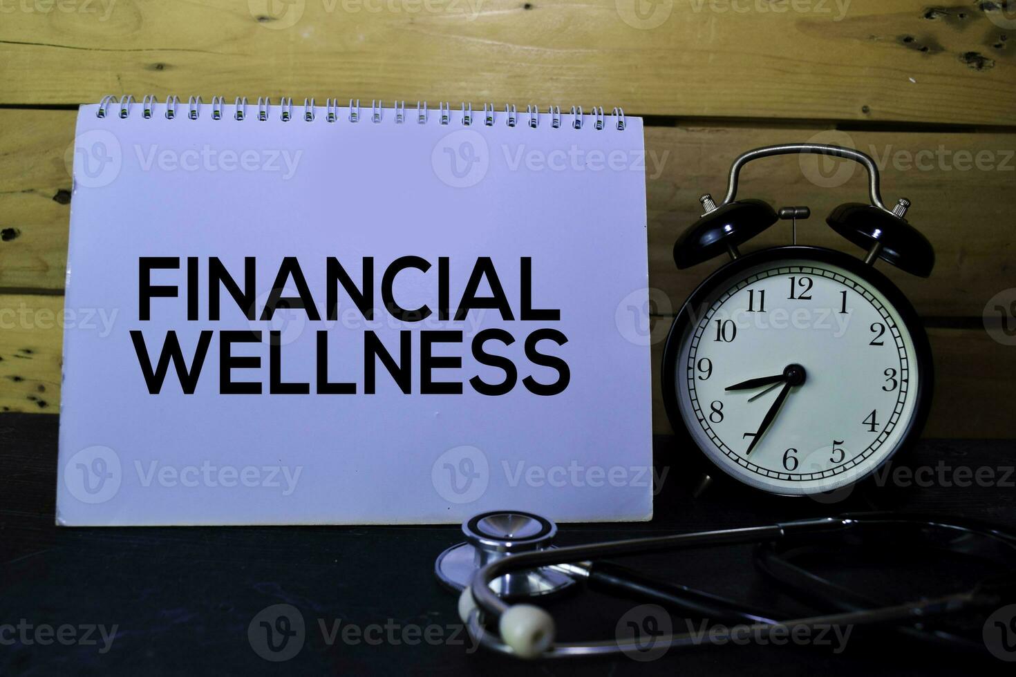 Financial Wellness write on book isolated on wooden table. Medical or Finance concept photo