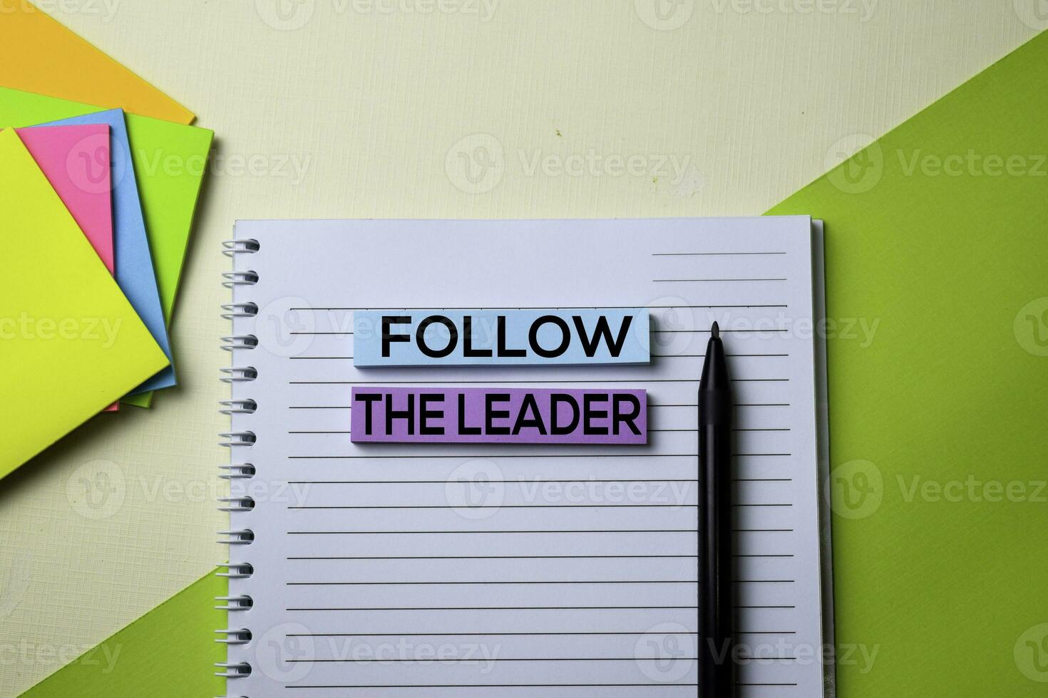 Follow the Leader text on top view office desk table of Business workplace and business objects. photo