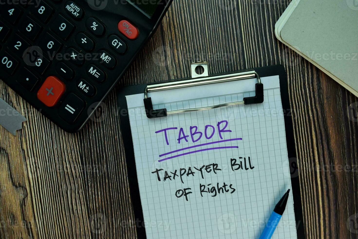 TABOR - Taxpayer Bill of Rights write on a paperwork isolated on Wooden Table. Business or Financial Concept photo