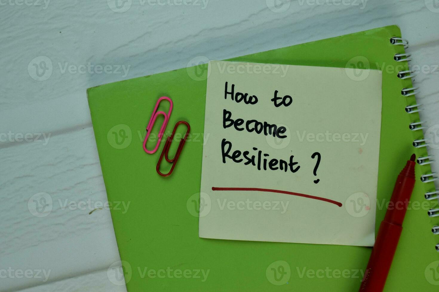 How to Become Resilient write on sticky note isolated on Wooden Table. photo