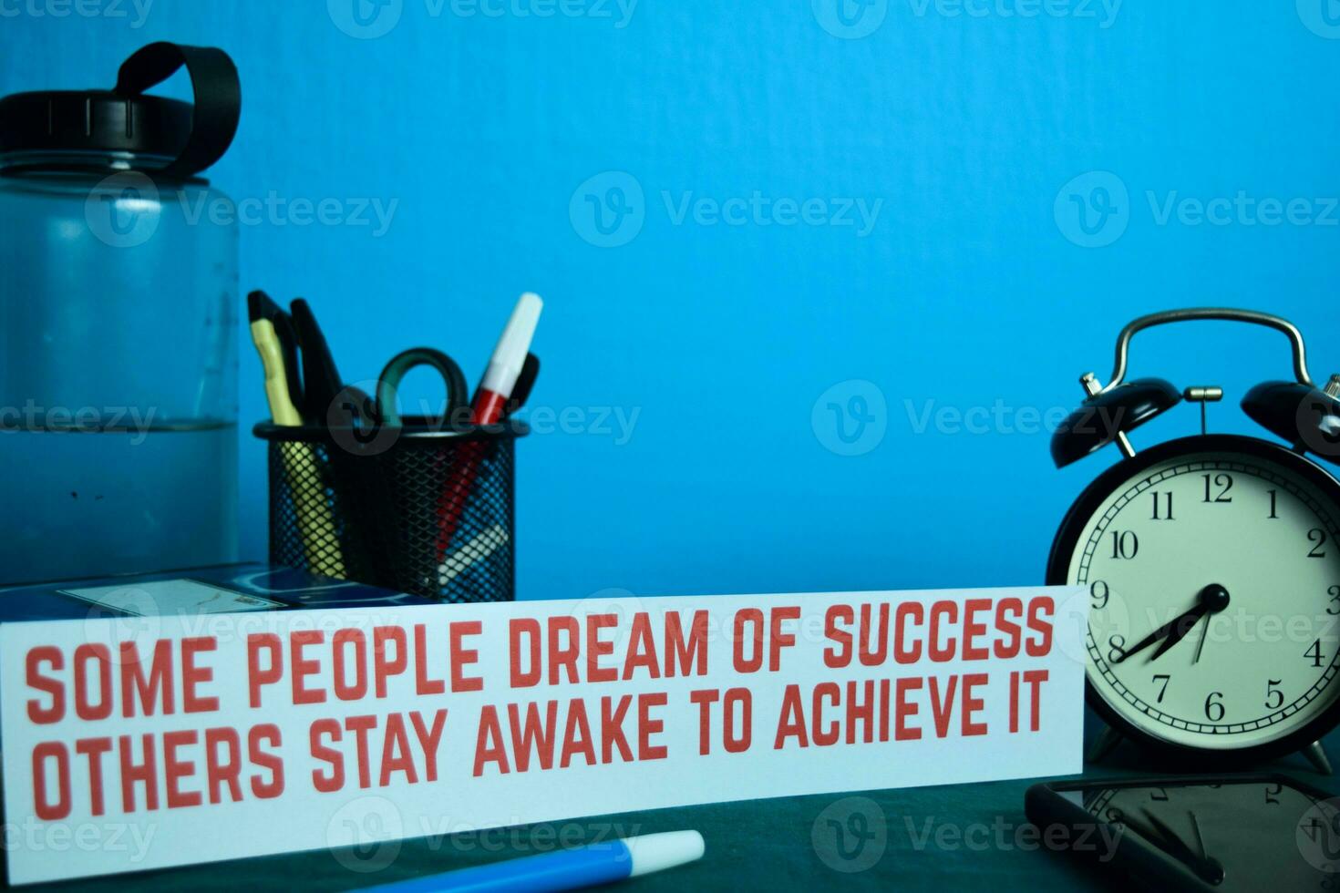 some people dream of success others stay awake to achieve it Planning on Background of Working Table with Office Supplies. Business Concept Planning on Blue Background photo