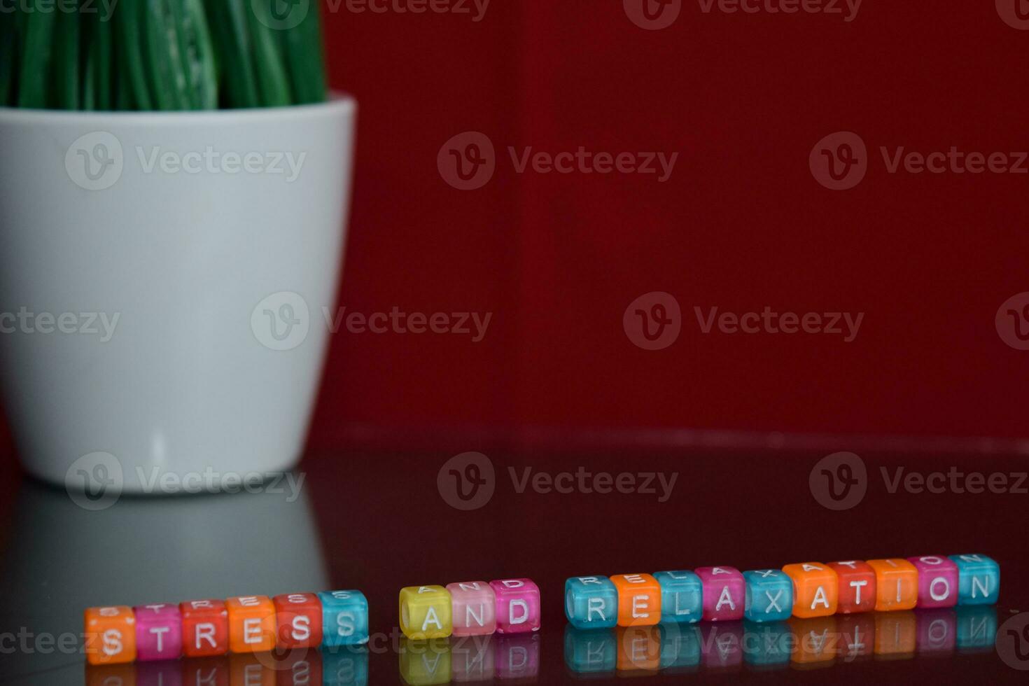 Stress and relaxation text at colorful wooden block on red background. Desk office and education concept photo