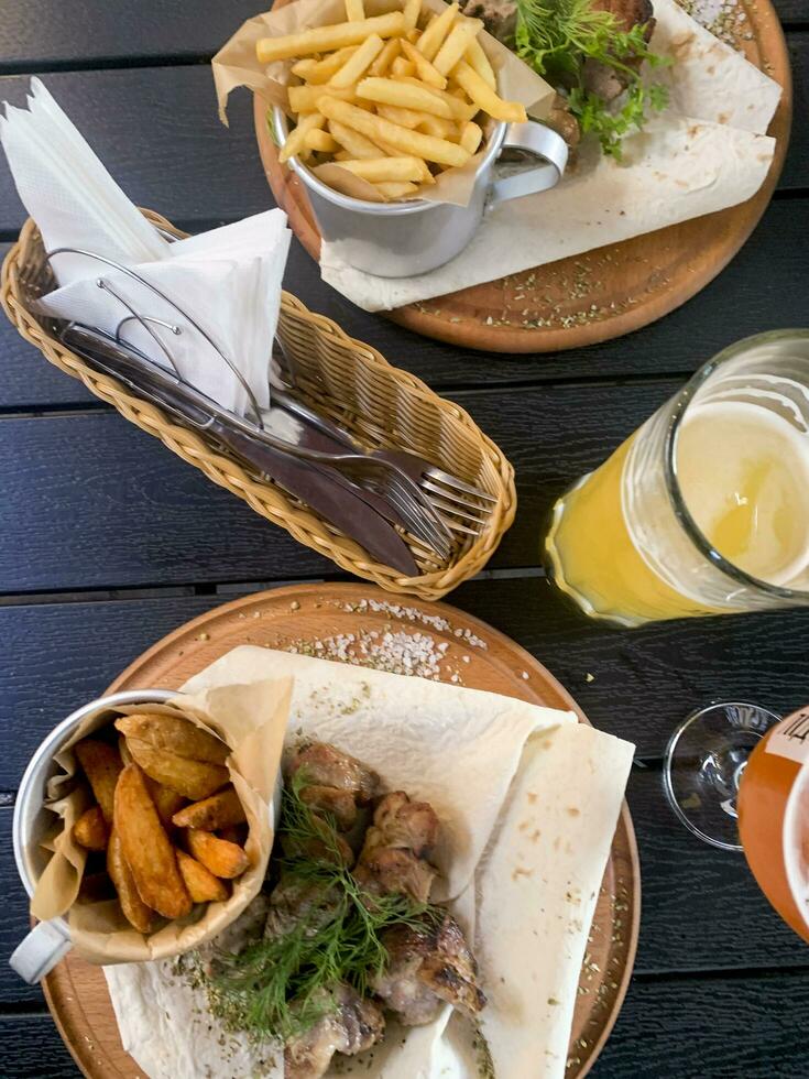 Street fast food, French fries, pita bread and pieces of grilled meat. Studio Photo