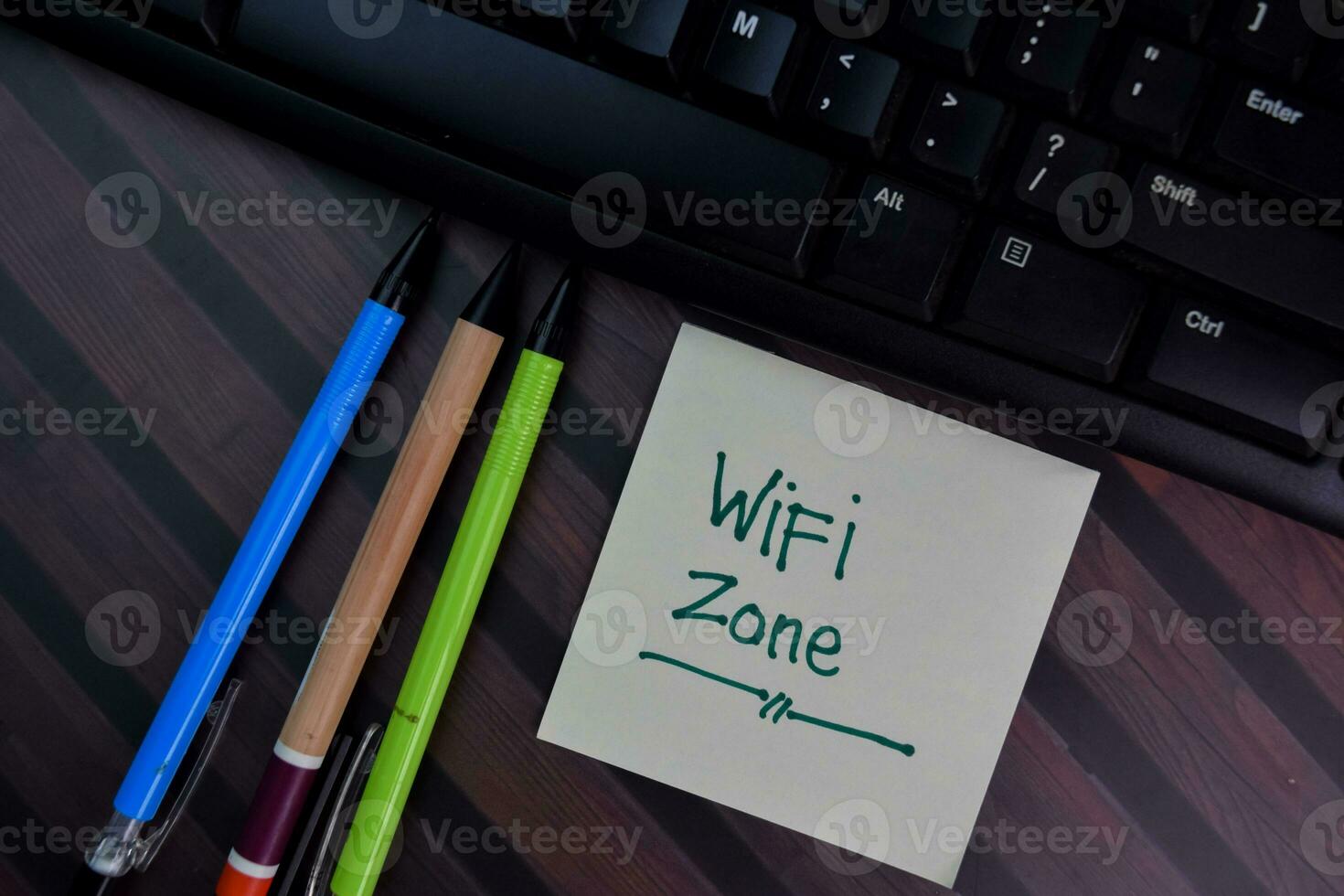 Wifi zone write on sticky notes isolated on Wooden Table. photo