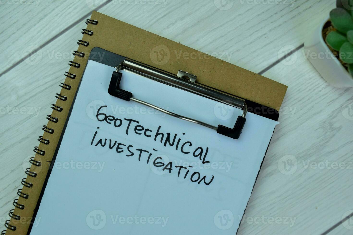 Concept of Geotechnical Investigation write on paperwork isolated on Wooden Table. photo