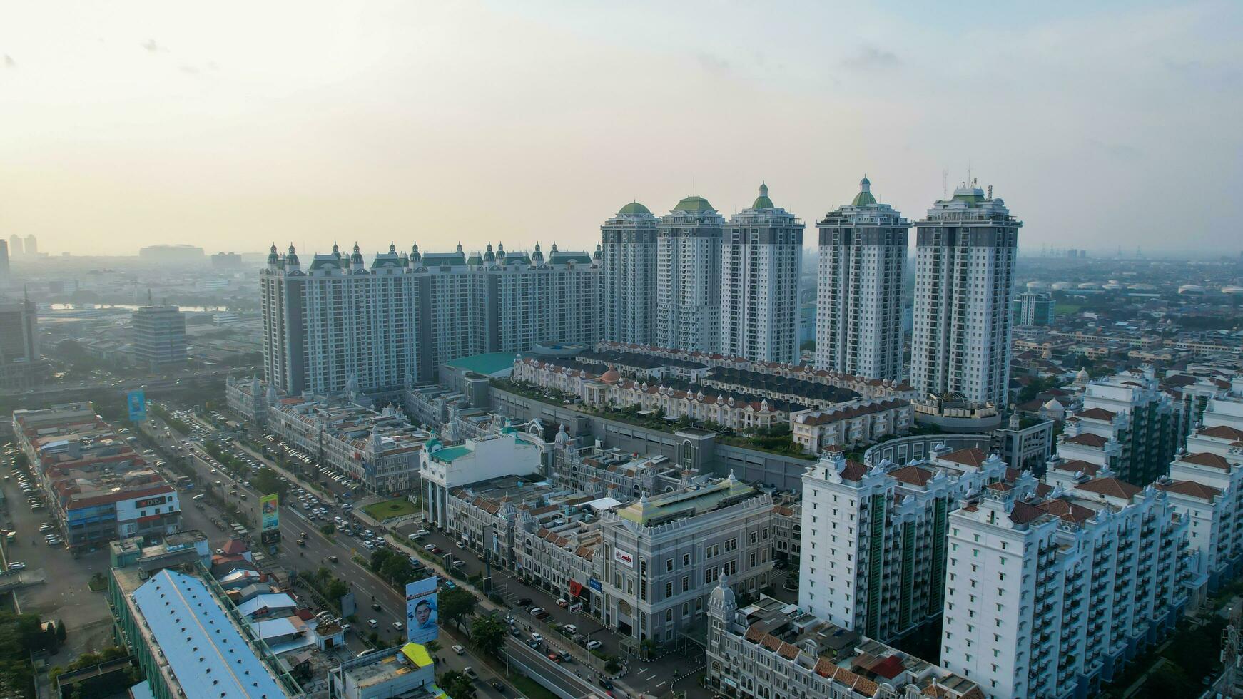 Aerial view of new green urban landscape in the city. Cityscape of a residential area with modern apartment buildings when sunset with noise cloud. Jakarta, Indonesia, Juni 23, 2022 photo