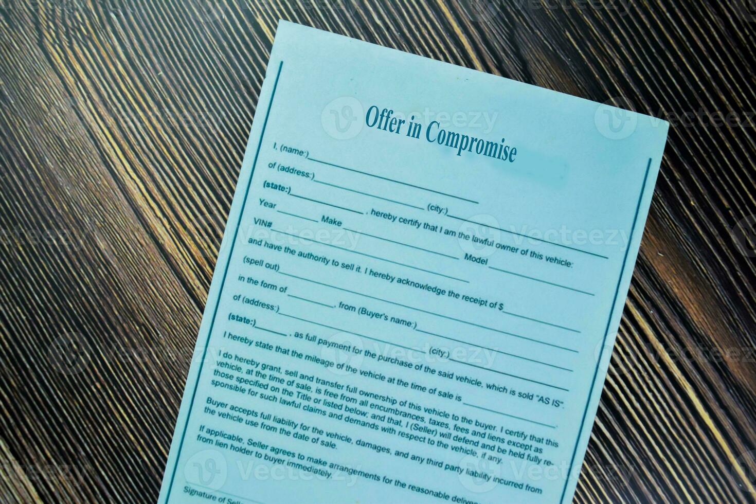Concept of Offer in Compromise isolated on Wooden Table. photo