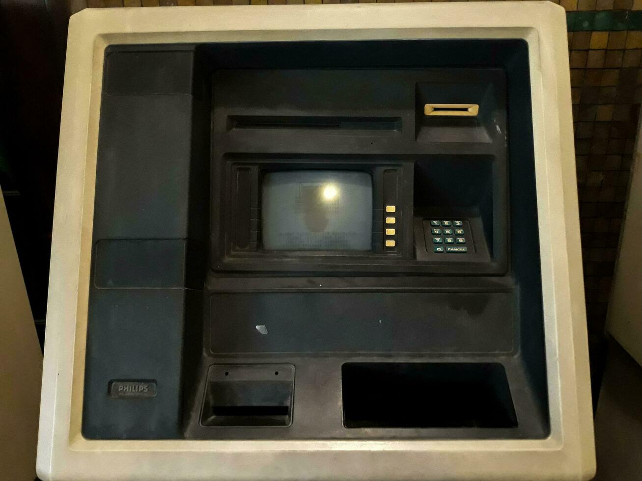 A gray old ATM in the wall. Black frame. Still life in Museum Mandiri. JAKARTA, INDONESIA, APRIl 8, 2019 photo