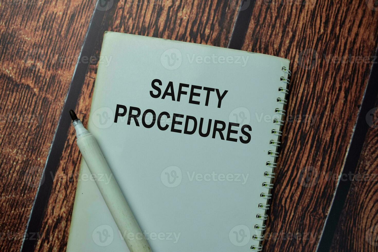 Safety Procedures write on a book isolated on office desk. photo