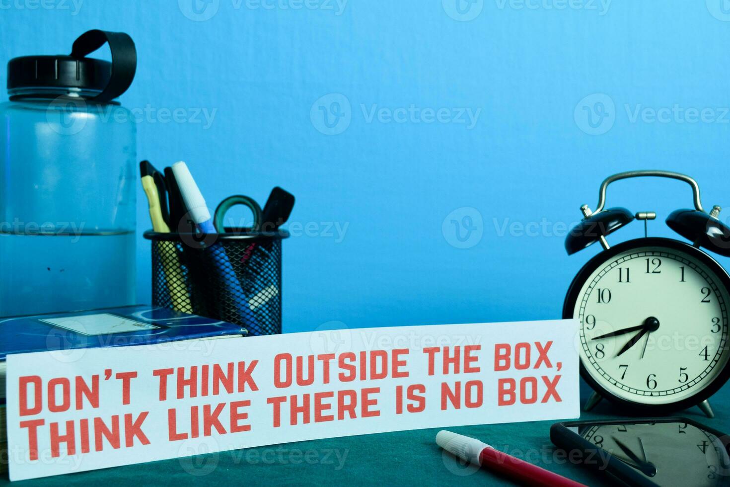 Don't think Outside the box, Think like there is no box Planning on Background of Working Table with Office Supplies. Business Concept Planning on Blue Background photo