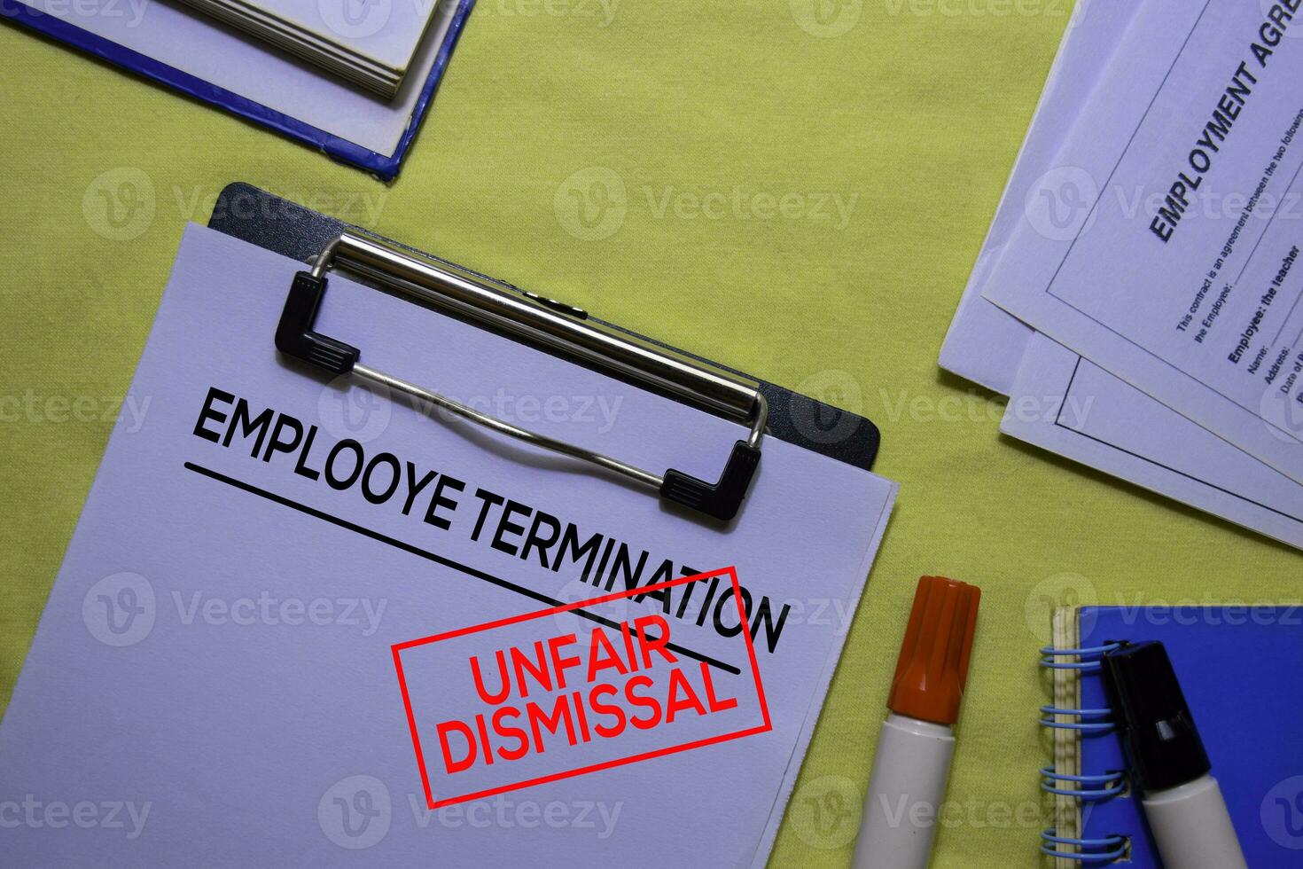 Employee Termination text on Document form and Stamp Unfair Dismissal isolated on office desk. photo