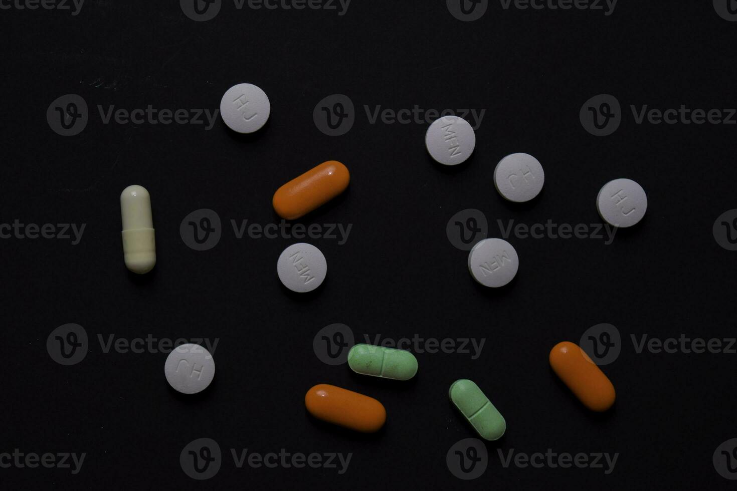 colorful medication and medicine pills, tablets and capsules. Isolated on office desk background. Medical or Healthcare concept photo