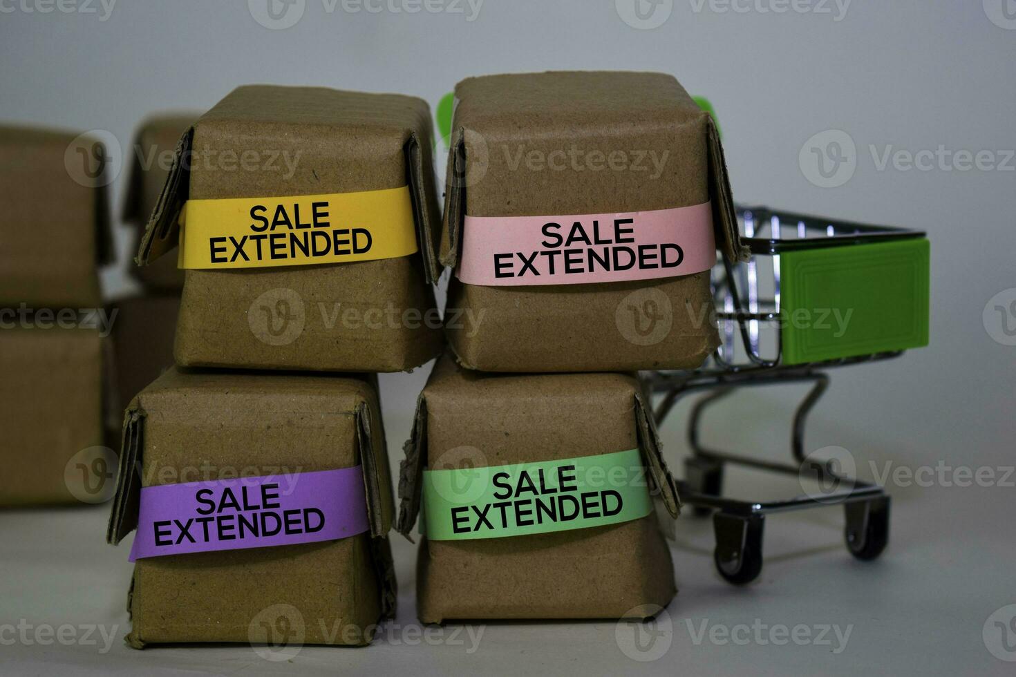 Sale Extended Text in small boxes and shopping cart. Concepts about online shopping. Isolated on white background photo