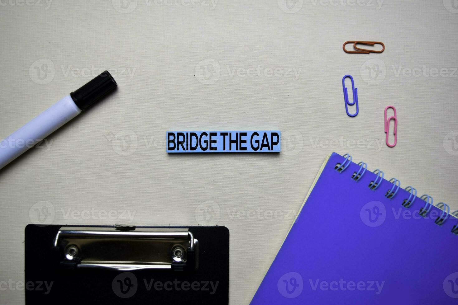 Bridge the Gap text on sticky notes with office desk concept photo