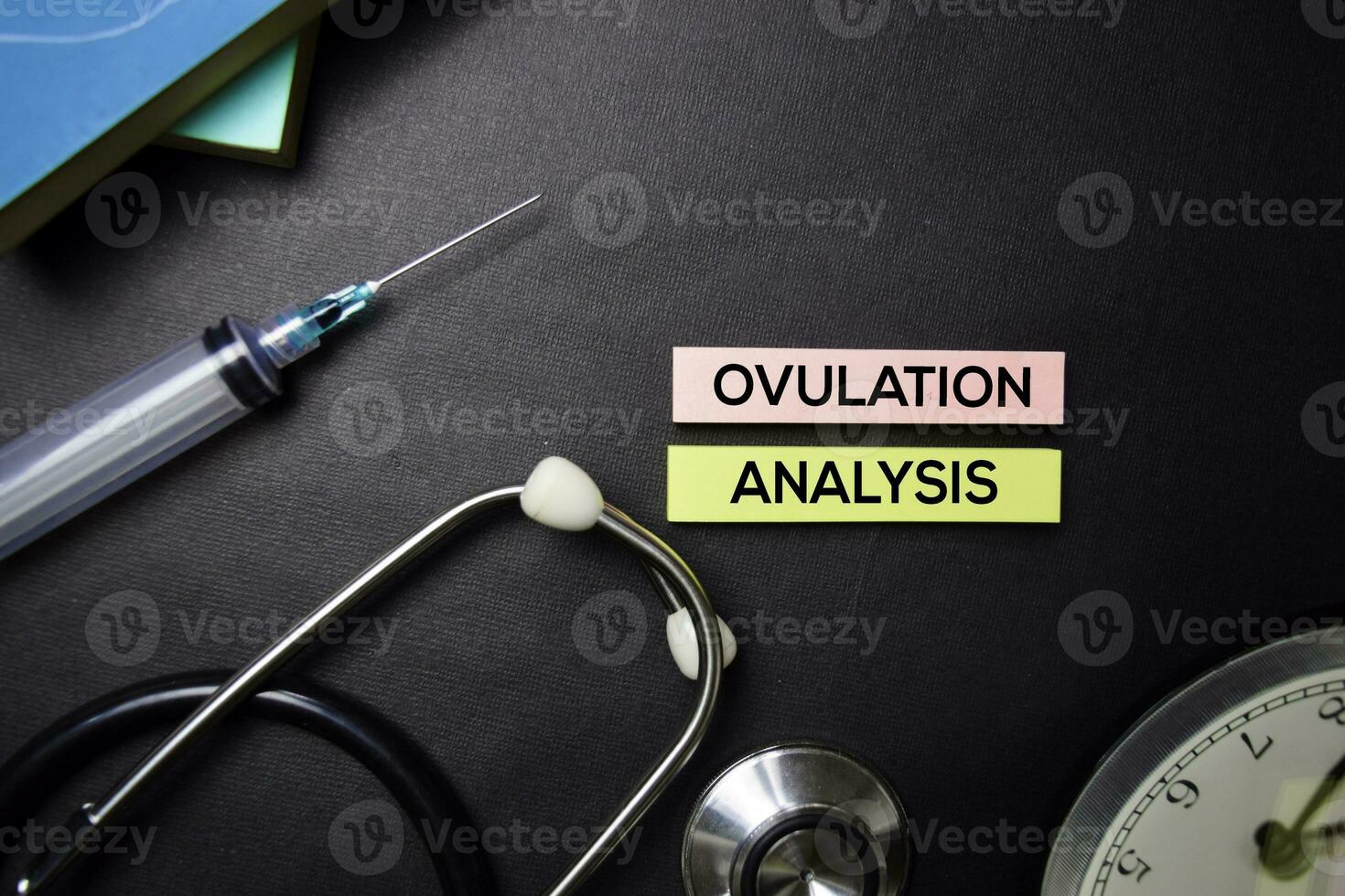 Ovulation Analysis text on Sticky Notes. Top view isolated on black background. Healthcare Medical concept photo
