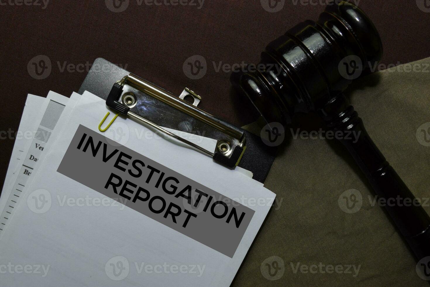 Investigation Report Document form and Black Judges gavel on office desk. Law concept photo