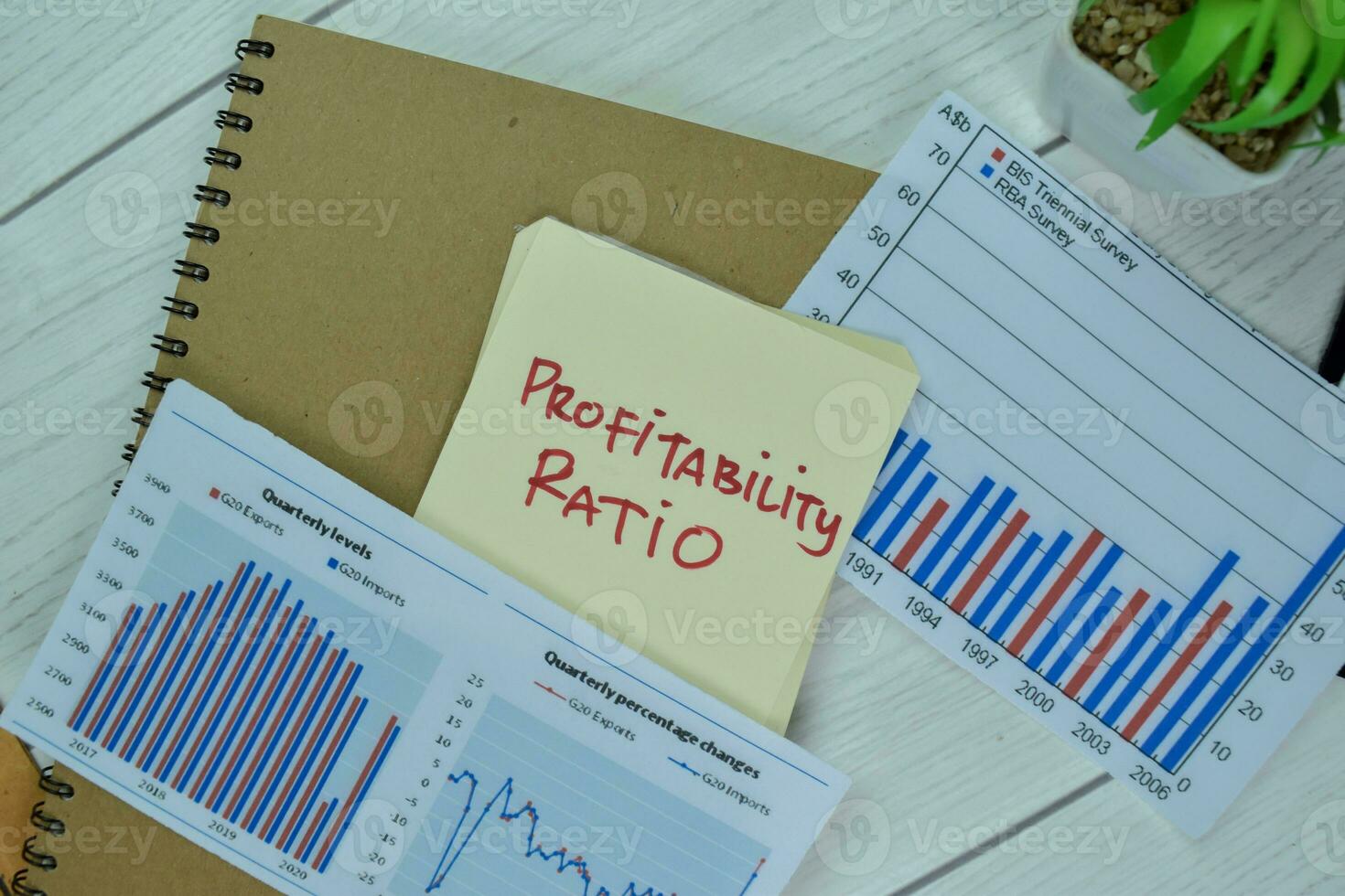Concept of Profitability Ratio write on sticky notes isolated on Wooden Table. photo