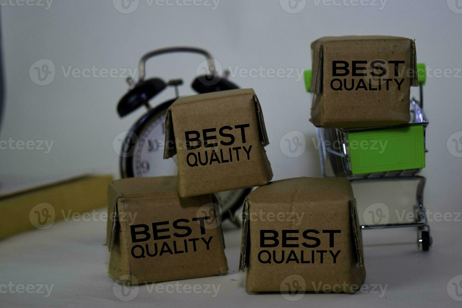 Best Quality Text in small boxes and shopping cart. Concepts about online shopping. Isolated on white background photo