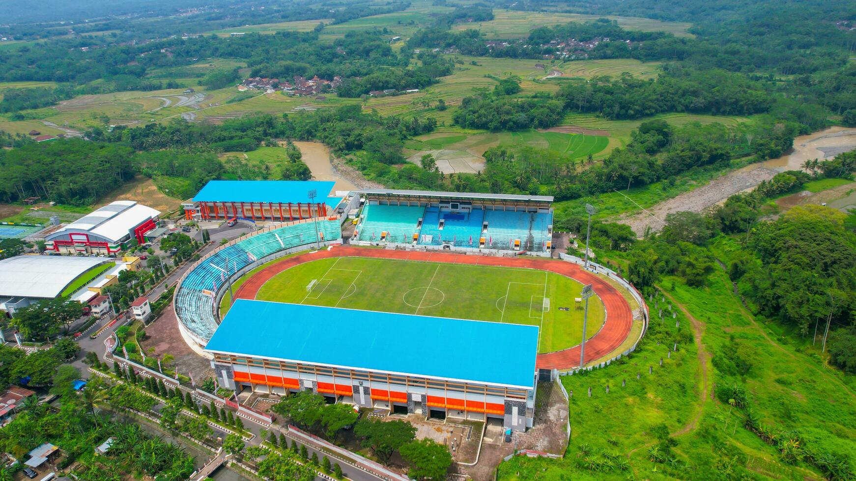 Aerial top down view of the Beautiful scenery of Moch. Soebroto Stadium. with Magelang cityscape background. Magelang, Indonesia, December 6, 2021 photo