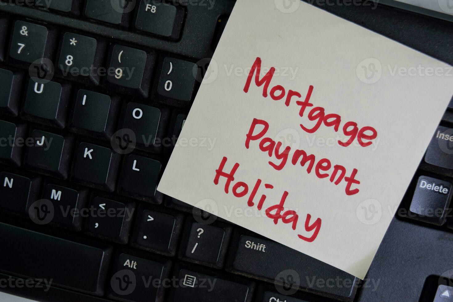 Mortgage Payment Holiday write on sticky notes isolated on Wooden Table. photo