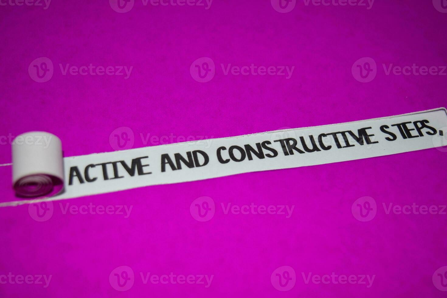 Active and Constructive Steps text, Inspiration and positive vibes concept on purple torn paper photo